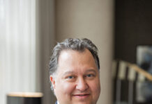Prostate cancer expert Ben Lowentritt poses for a photo behind a blurred background