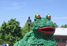 A participant rides a frog-shaped sculpture in a previous Kinetic Sculpture Race