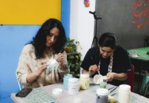 People painting pottery together