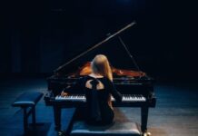 A woman playing a grand piano
