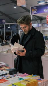 A man looks through a book at a book sale